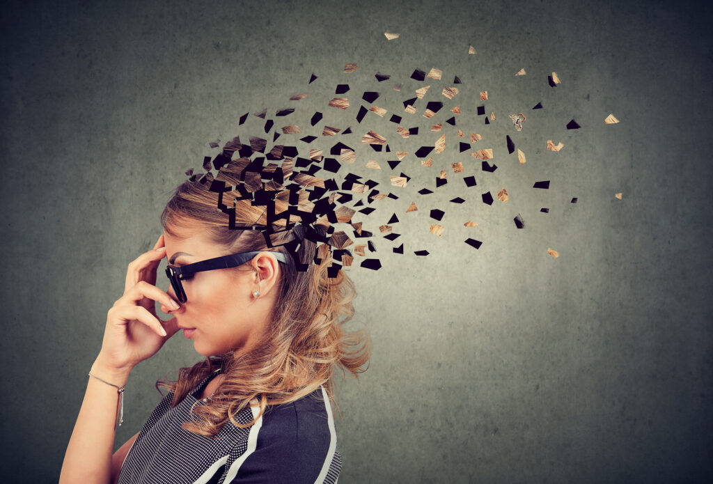 Side profile of a woman losing parts of her head as symbol of decreased mind function.