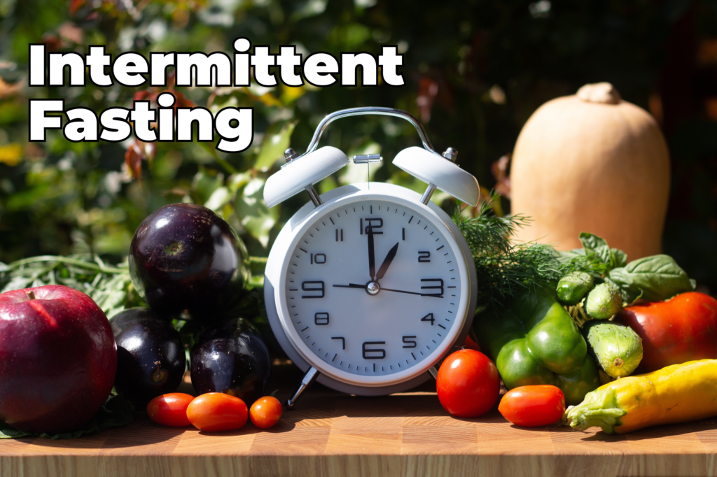 A clock with vegetables and fruits surrounding it with the title "Intermittent Fasting"