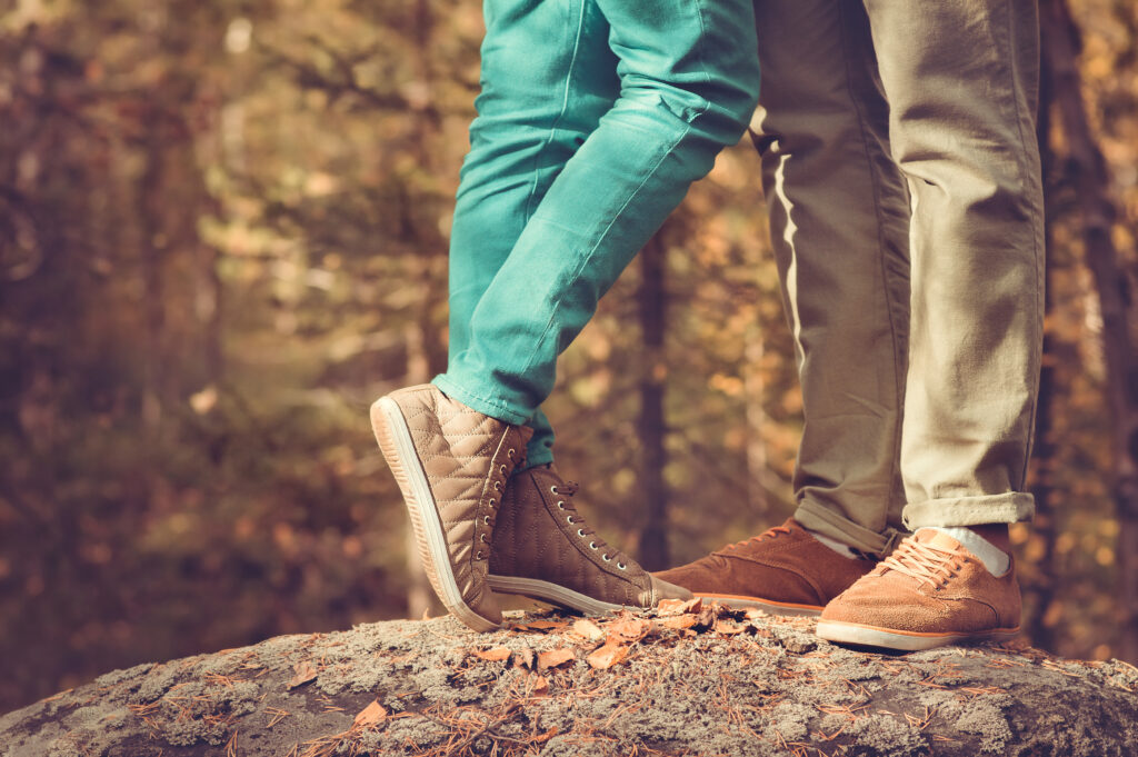 Couple Man and Woman Feet in Love Romantic Outdoor Lifestyle with nature on background