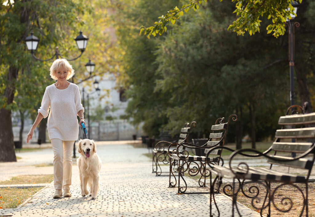 Woman walking with dog in park